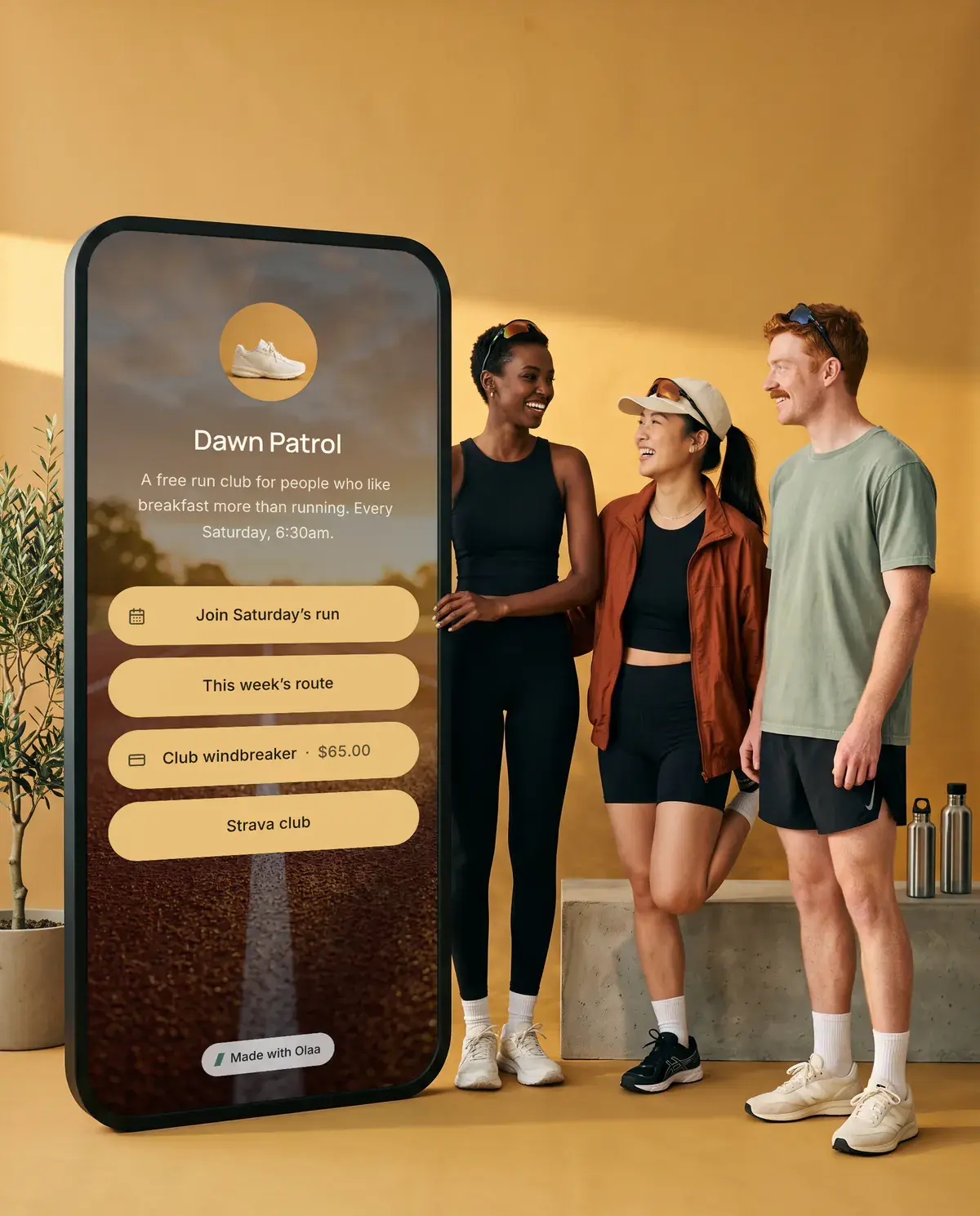 Dawn Patrol, Saturdays at 6:30. Beside them stands a giant phone showing their Olaa page.