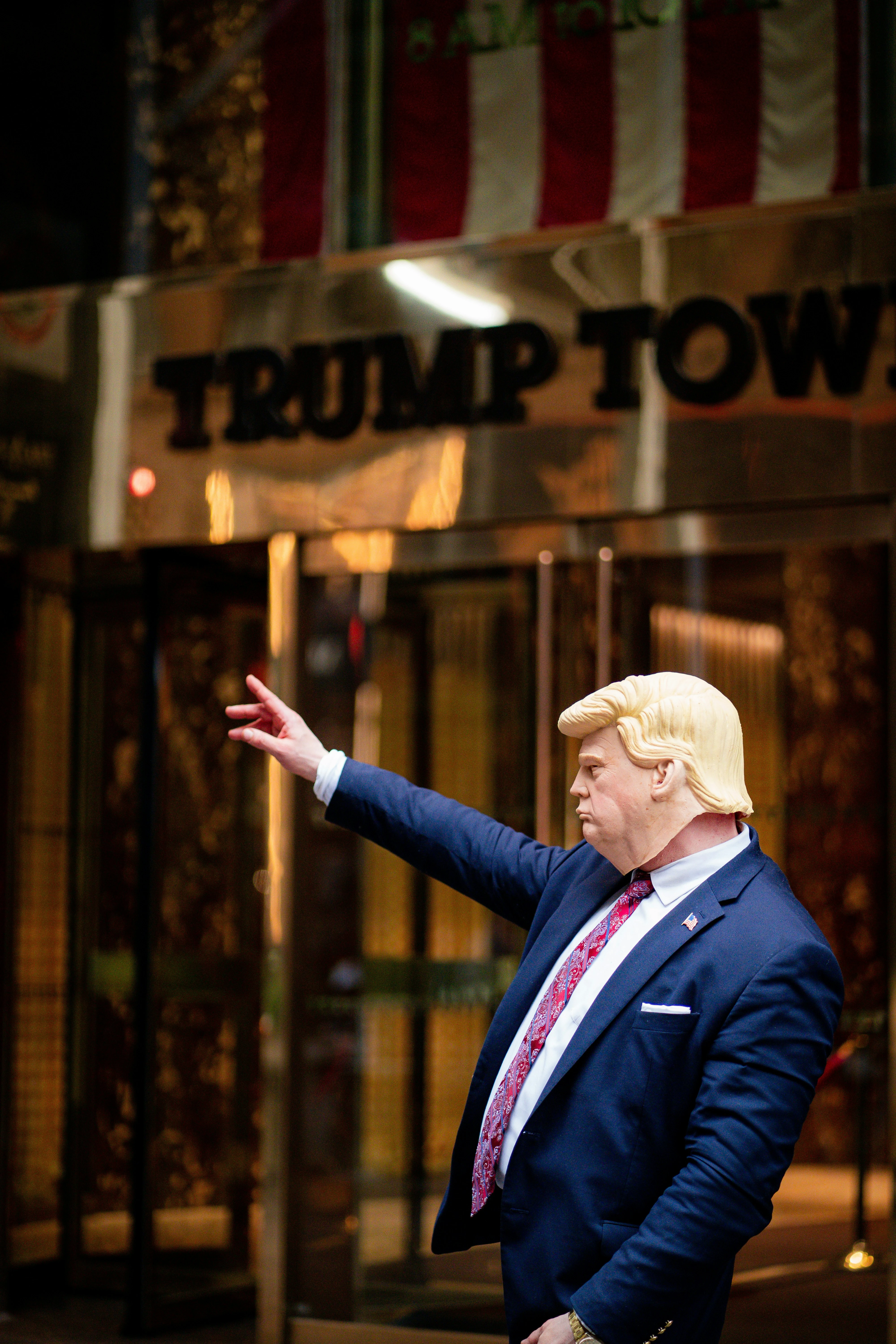 Impersonator with a face mask of Trump